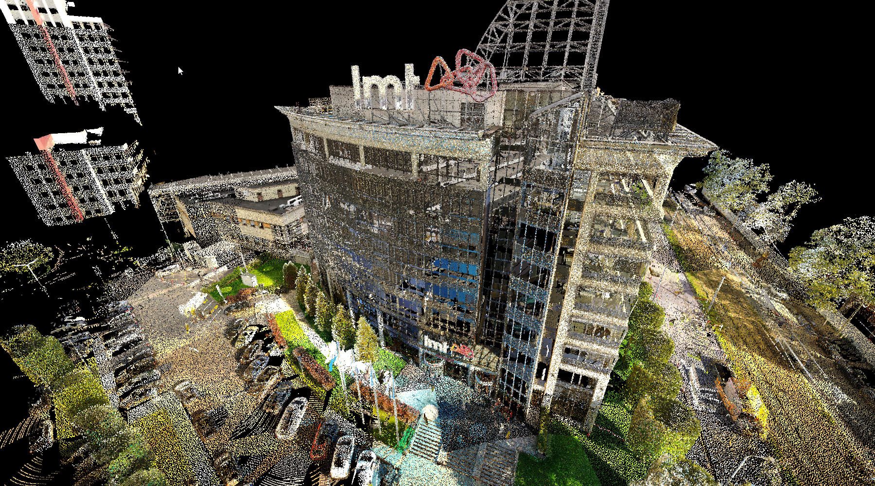 Raw aerial LiDAR scan of the LMT headquarters in full colour, building, car park and trees captured as dense points.