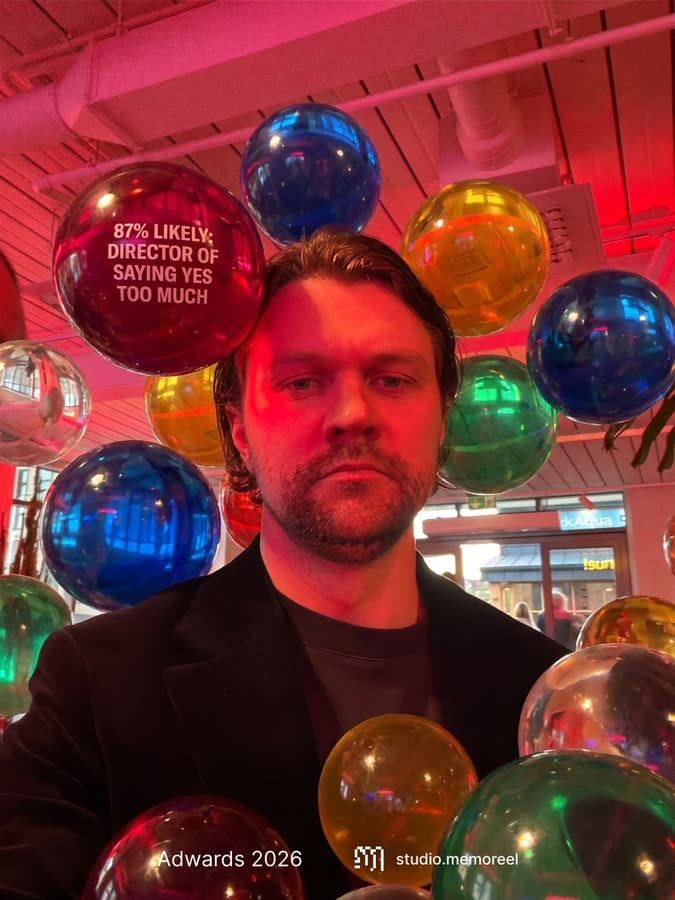 Generated portrait of a man in a black blazer under red light, with an orb labelled 'Director of saying yes too much'.